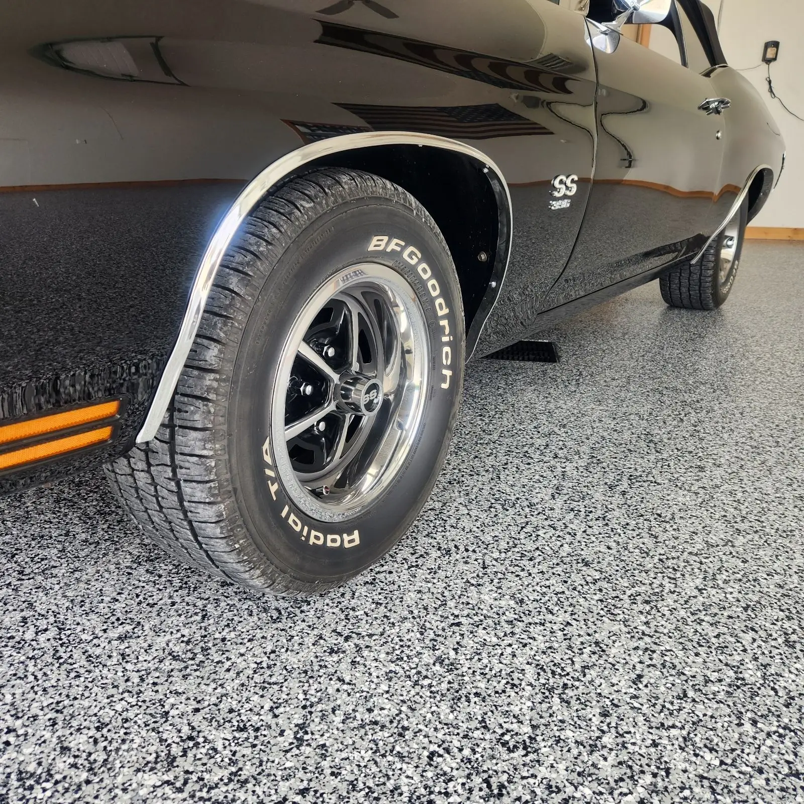 Black car in a garage with an epoxy floor